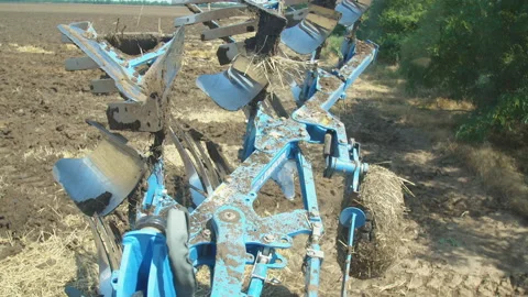 A blue plow plows the ground Stock Footage 120596517