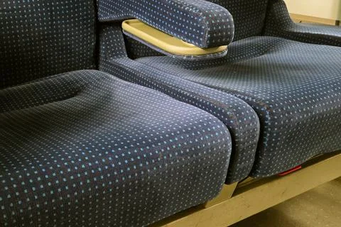 Blue polka dot patterned seats in a public transport setting, showcasing the  Stock Photos