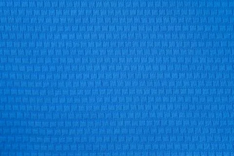Blue polyester fabric background. A fragment of a t-shirt for sports. Close-u Stock Photos