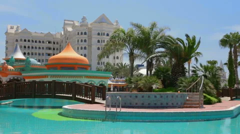 Blue pool, palm trees and hotel. Stock Footage 49819339