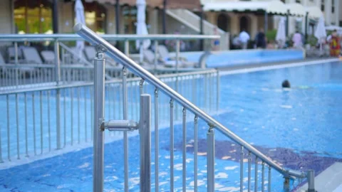 Blue pool steps under bright sunlight, no people in 4k slow motion 60fps Stock Footage 284309614