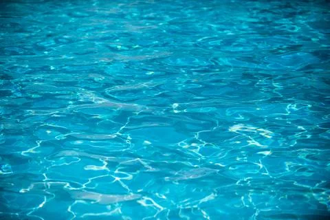 Blue pool water background. Blurred transparent clear calm water surface texture Stock Photos