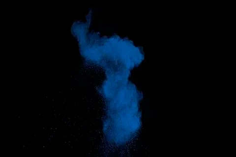 Blue powder explode cloud on black background.Launched blue dust particles. 스톡 사진