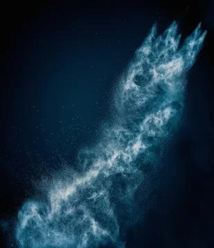 Blue powder exploding isolated on black Foto stock