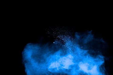 Blue powder explosion cloud on black background.Launched blue dust particle. Stock Photos