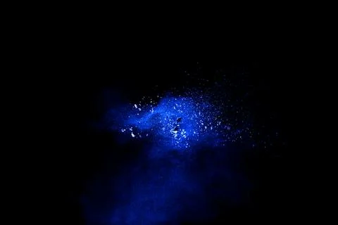 Blue powder explosion cloud on black background. Stock Photos