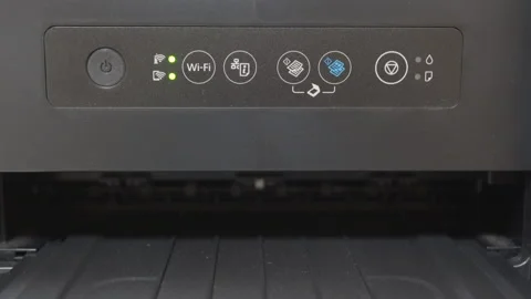 The blue power button on a black plastic inkjet printer flashes Stock Footage 321404360