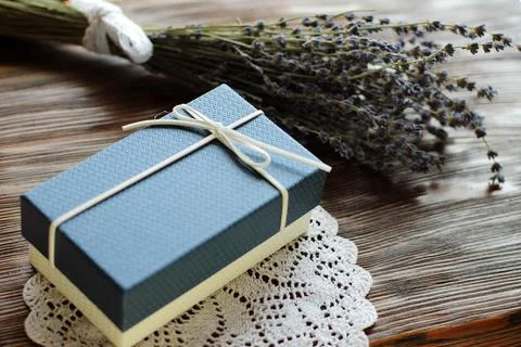 Blue present box for man with lavender flower on wooden table Stock Photos