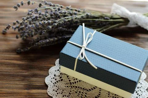Blue present box for man with lavender flower on wooden table, vintage deco.. Stock Photos