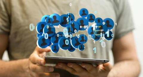 Blue profile icons with binary numbers hovering above the person's hands holding Stock Photos