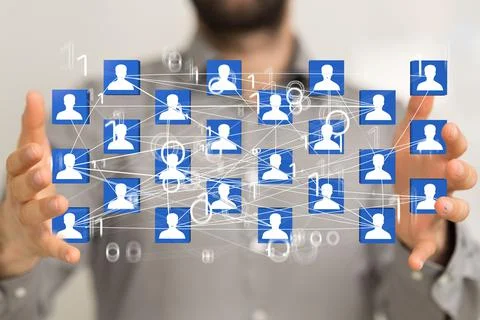 Blue profile icons with binary numbers hovering between the person's hands. Stock Photos