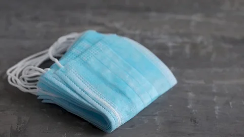 Blue protective masks on ceramic background. Video stock 125755392