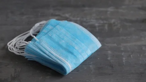 Blue protective masks on ceramic background. Video stock 127976869
