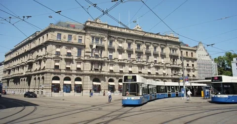 Blue public transit trams crossing Paradeplatz in front of UBS bank in Zurich Stock Footage 341854258