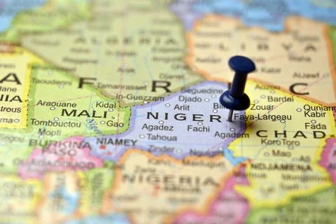 Blue Push Pin Highlighting Niger on Vintage Paper World Map Macro Close Up Stock-Fotos