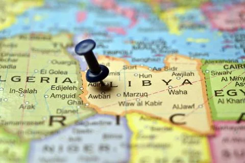 Blue Push Pin Marking Libya on Blurred World Map Macro Close Up Travel Back.. 写真素材