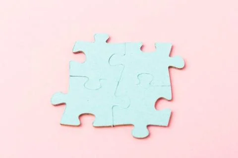 Blue puzzle pieces with empty space for your text and design on pink backgrou Stock Photos