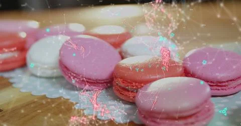 Blue QR code with a red floating web of connections over pink macaronies lying 库存插图