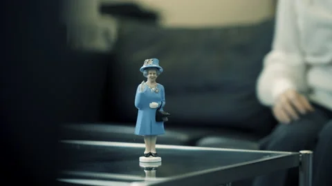 Blue Queen figure waving on table | 4K Stock Footage 219704475