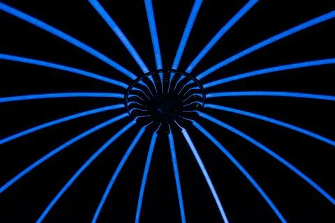 Blue radial light pattern on black background Stock Photos
