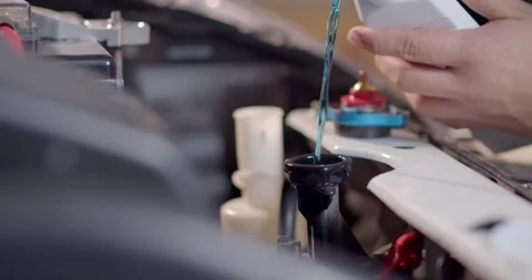 The blue radiator water.Adding Coolant to Car radiators or Pouring. Stock Footage 277843222