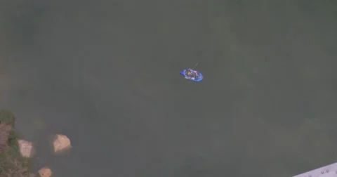 Blue Raft Passes Under a Bridge Stock Footage 65234538