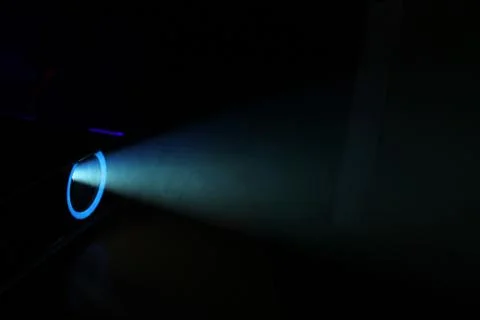 Blue rays of light through the smoke from the projector. Lighting equipment.  Stock Photos