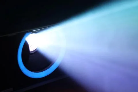 Blue rays of light through the smoke from the projector. Lighting equipment.  Stock Photos