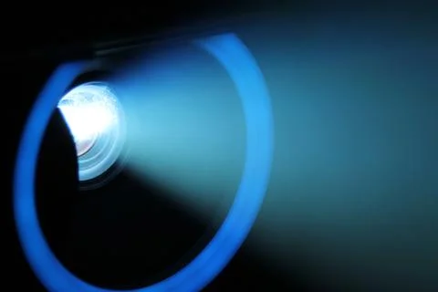 Blue rays of light through the smoke from the projector. Lighting equipment.  Stock Photos