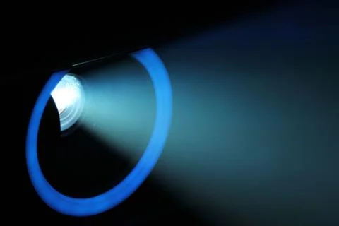 Blue rays of light through the smoke from the projector. Lighting equipment.  Stock Photos
