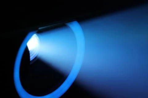 Blue rays of light through the smoke from the projector. Lighting equipment.  Fotos de archivo