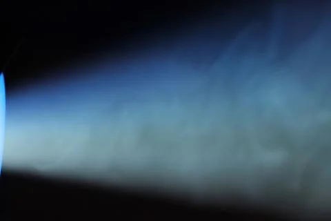 Blue rays of light through the smoke from the projector. Lighting equipment.  Stock Photos