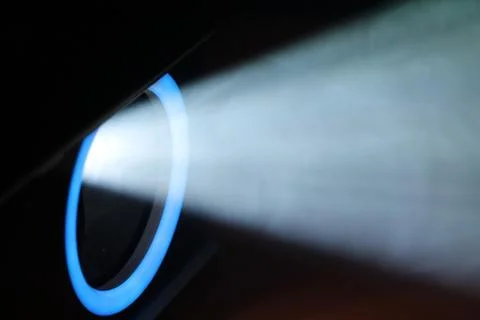 Blue rays of light through the smoke from the projector. Lighting equipment.  Stock Photos