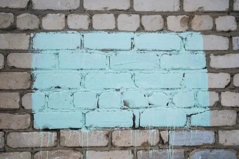 Blue rectangle on a brick wall. Colored place for text. Stock Photos