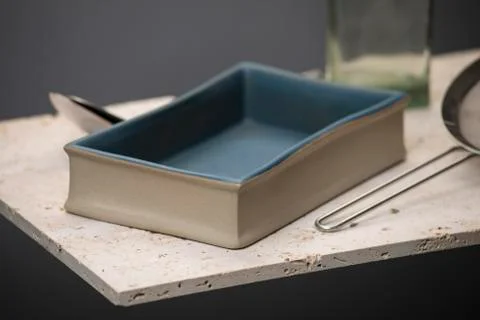 Blue Rectangular Deep Dish with Spoons, Strainer, and Jar Stock Photos