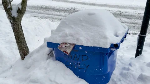 Blue Recycling or Trash Bin is covered in snow during a snowstorm Stock Footage 145293102