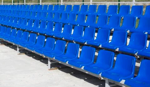 Blue, red, white rows of seats on the stadium Stock Photos