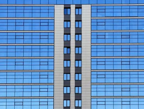 The blue reflection of the sky in the windows. Stock Photos