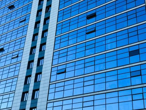 The blue reflection of the sky in the windows. Stock Photos
