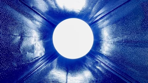 Blue reflective lamp interior with glowing circular bulb creating abstract light Stock Footage 327130899