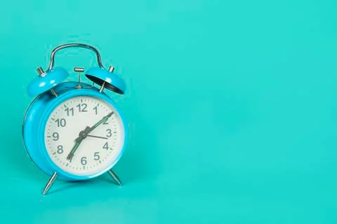 Blue retro clock on a blue background with copy space Stock Photos