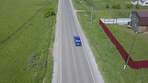 Blue retro russian car rides on the road in the village view from the drone 스톡 동영상 129345337