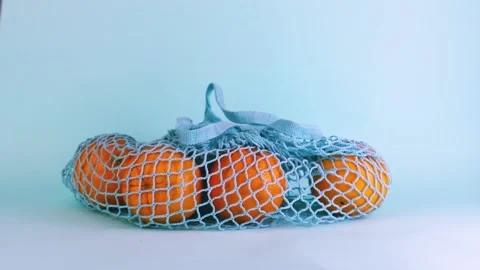 A blue reusable bag with oranges was taken from the table on a blue background. Stock Footage 169093699
