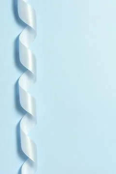 Blue ribbon for wrapping a gift on a solid pink background Stock Photos