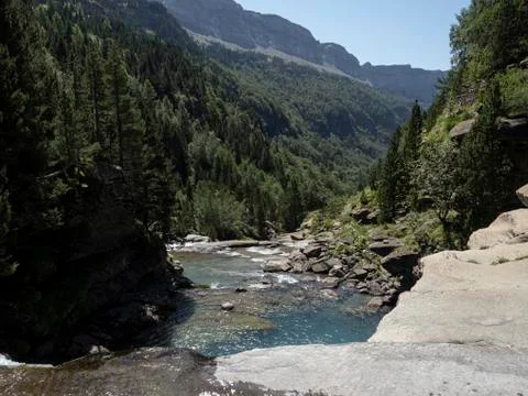 Blue river going down through the mountains 스톡 사진