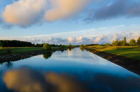 Blue river. Reflection of clouds in the water Stock Photos