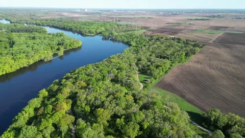 Blue River Surrounded By Green Forest and Aerial View of Trees and Farms Stock Footage 241863901