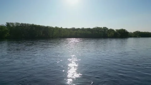 Blue River Surrounded By Green Forest and Trees Along Shoreline Flowing Water Stock Footage 241864156
