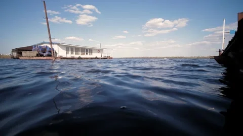 Blue river waves move slowly towards the horizon.Outdoors, sunny summer day. Video stock 130725726