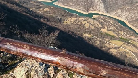 Blue river winds through rugged, dry mountains. Balkan, Eastern Europe, POV Video stock 331815395